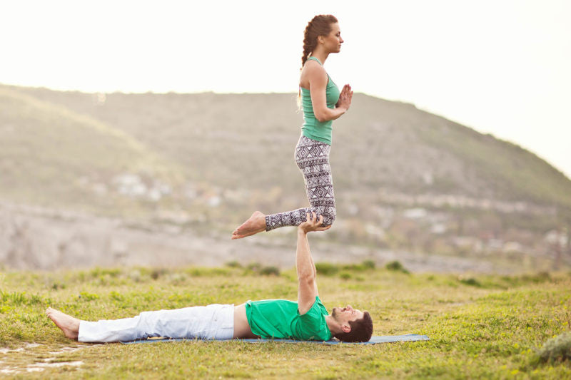 Premium Photo | Young latin american couple practicing a yoga pose outdoors  natural green background concept of wellness